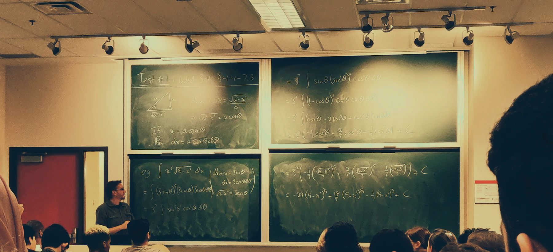 Students in a classroom in front of a chalkboard